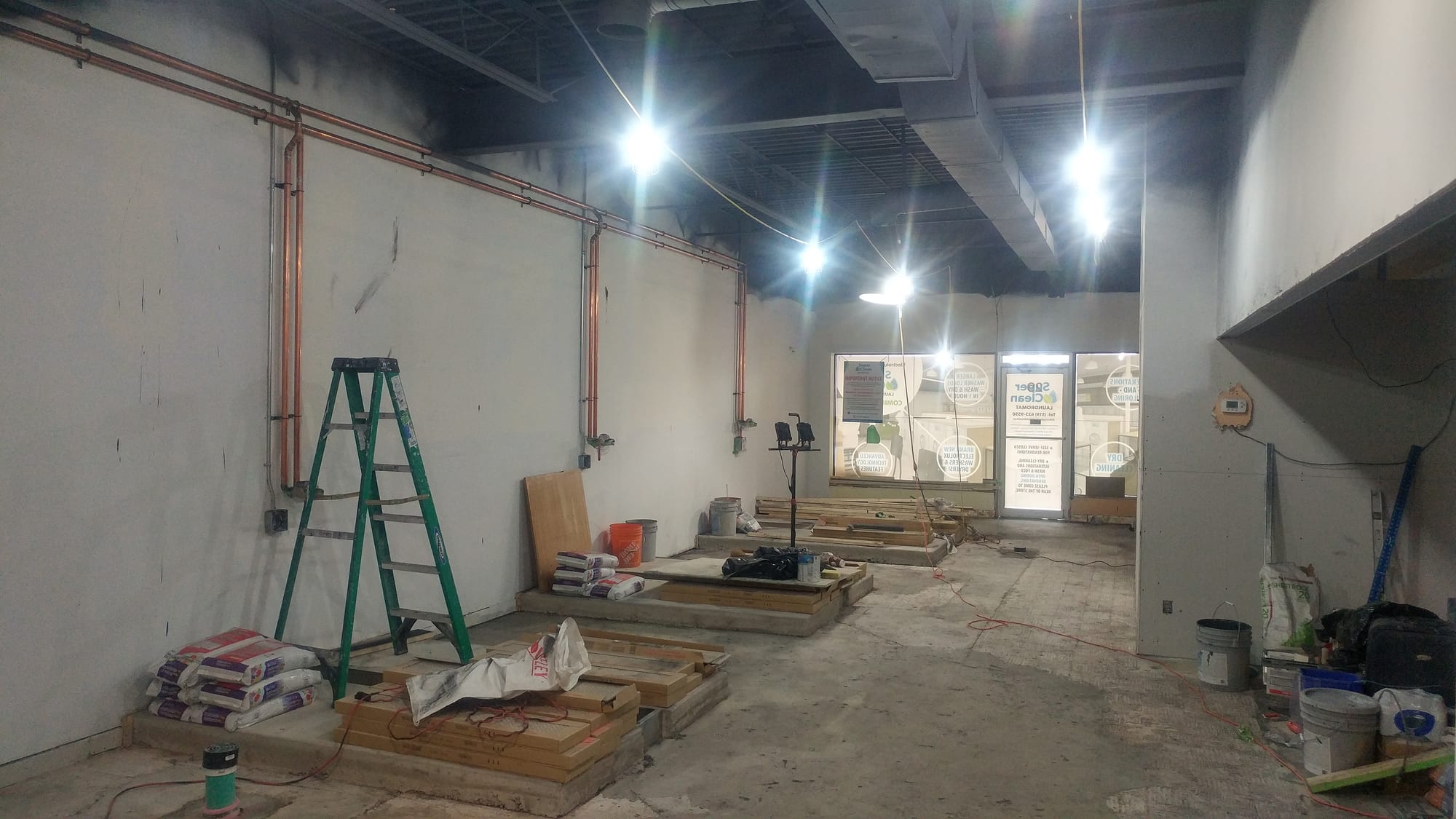 Construction in progress with exposed copper lines, platforms and ladders