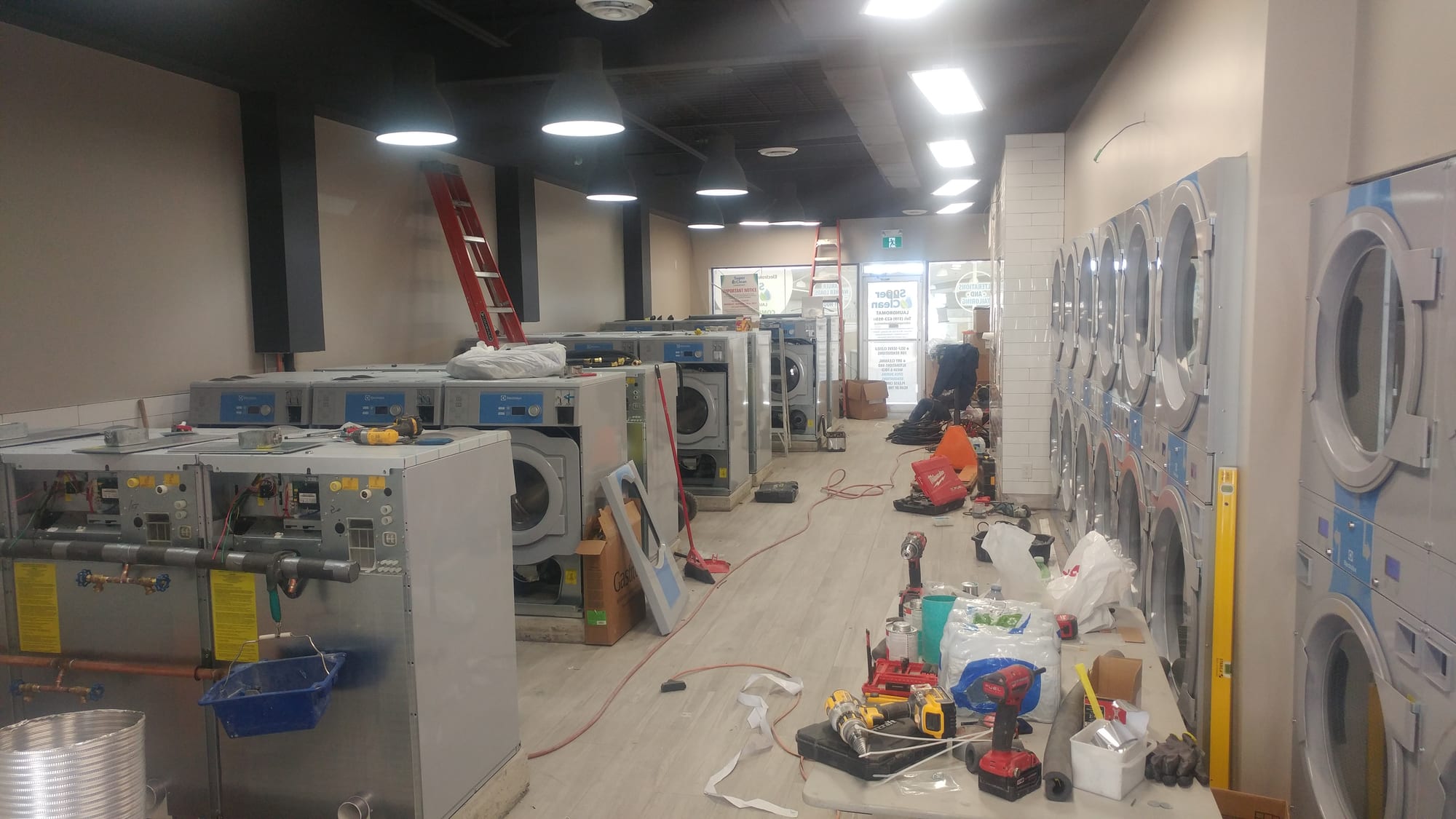 Commercial washers and dryers being installed during construction
